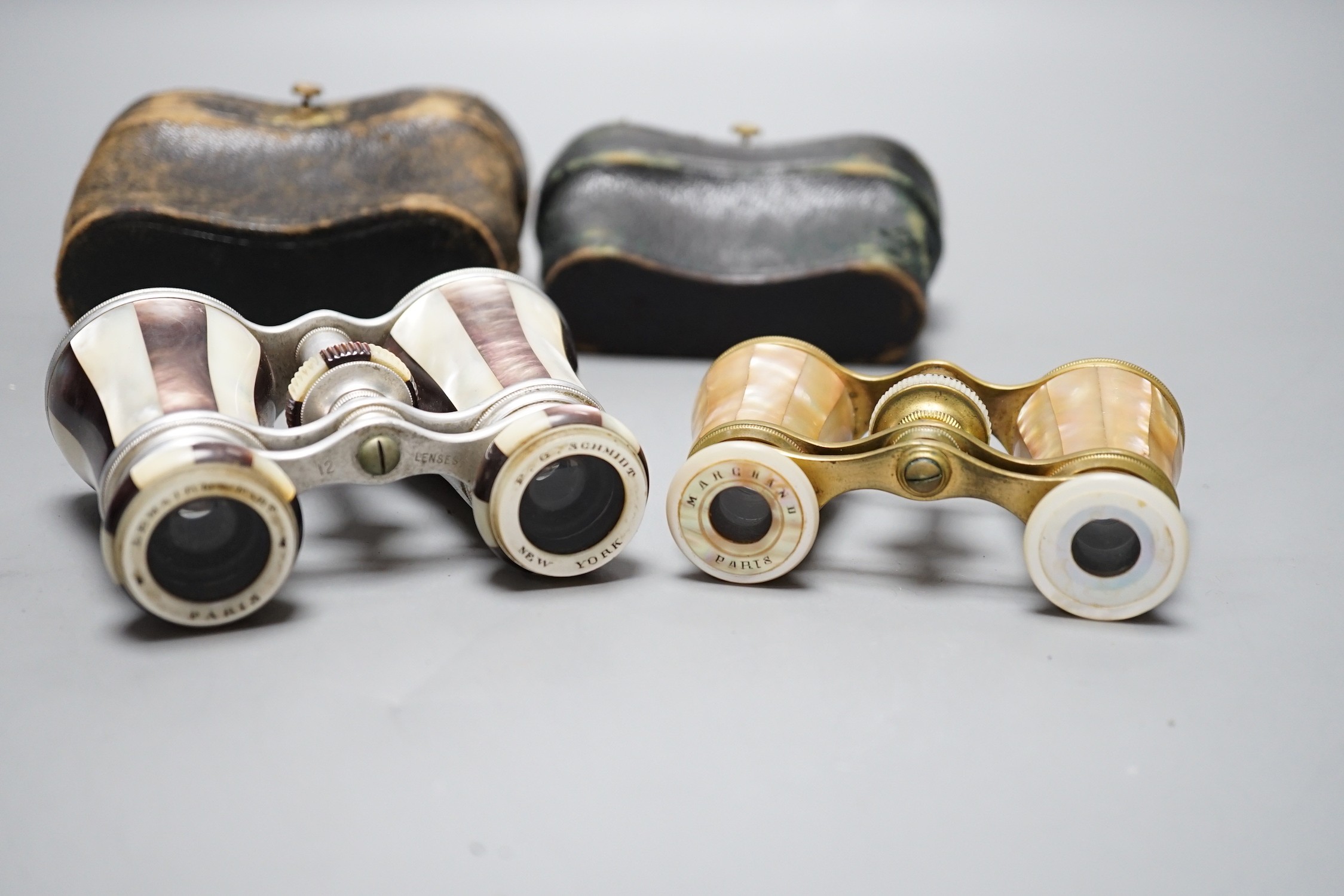 Two pairs of mother of pearl opera glasses; one marked Lemaire Fab, Paris to one lens and F.G. Schmidt, New York to the other, and Marghand Paris to the smaller pair